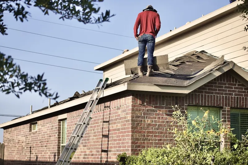 Professional roofer working on a residential roof in Chestnut Hill Estates